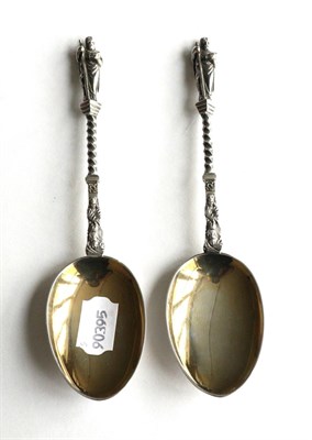 Lot 349 - A pair of Victorian cast silver fruit spoons with gilt bowls