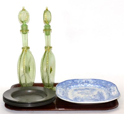 Lot 374 - A pair of decanters, six pewter plates and a blue and white platter