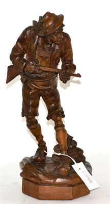 Lot 378 - An Austro German carved wooden figure of a Hunter dressed in traditional clothing with a rifle...