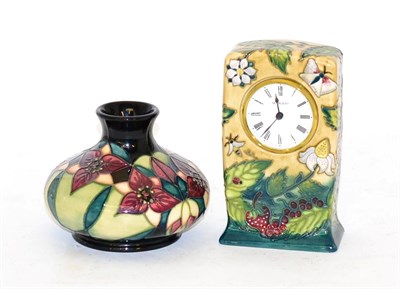 Lot 388 - A Moorcroft pottery timepiece in the Fruit Garden pattern by Nicola Slaney, 16cm and a...