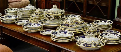 Lot 402 - An extensive Davenport porcelain dinner service, circa 1830, gilt with vine tendrils on a blue...