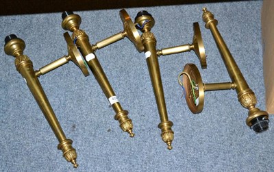 Lot 404 - Four Empire style gilt metal wall lights, with glass shades