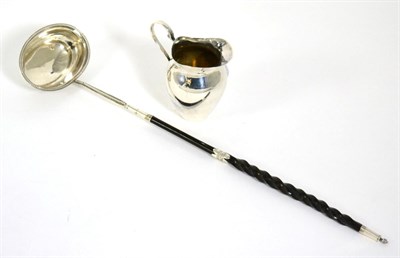 Lot 415 - A George III silver toddy ladle, makers mark TS, circa 1800; together with a small silver cream jug