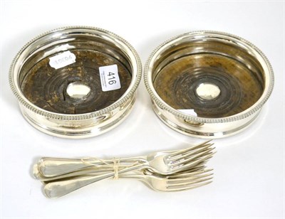 Lot 416 - Composite set of six silver Hanoverian pattern dessert forks and a pair of plated bottle coasters