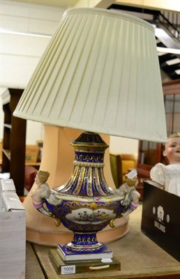 Lot 1009 - A continental gilt and hand painted porcelain table lamp, with caryatid twin handles