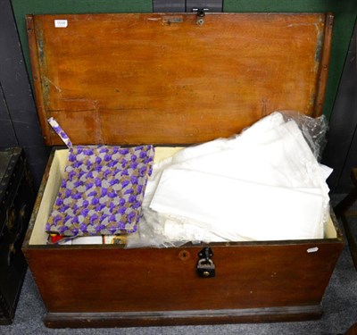 Lot 1038 - A wooden blanket box containing a quantity of linen together with another trunk