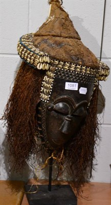 Lot 1081 - An African tribal mask on stand