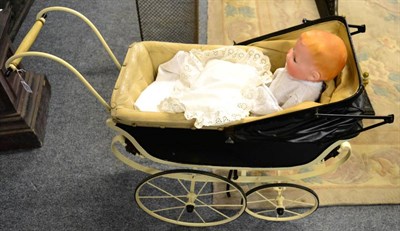 Lot 1128 - Dolls pram and Armand Marseille 352 bisque flange head doll on fabric body, with moulded hair, open