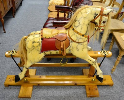 Lot 1129 - A painted rocking horse on trestle base