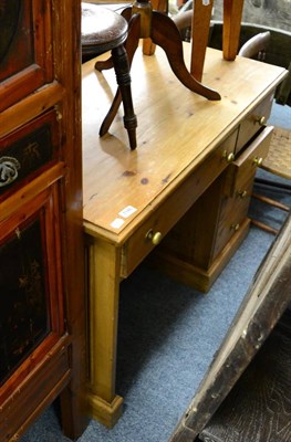 Lot 1146 - A pine kneehole desk with drawers