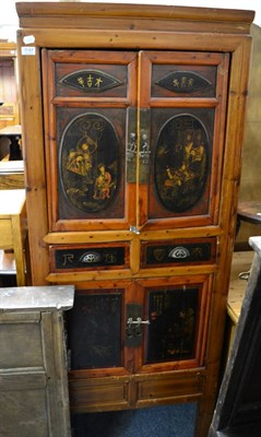 Lot 1147 - An Oriental cabinet with lacquered panels