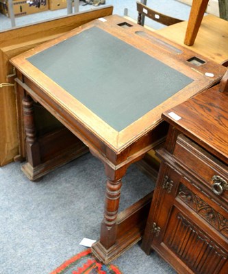 Lot 1151 - An early 20th century oak clerks desk, the back stamped 'Gillows'