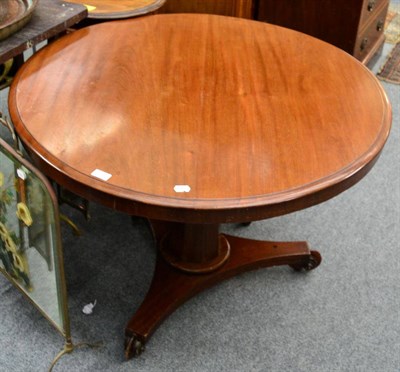 Lot 1152 - A mid 19th century mahogany tilt top breakfast table, raised on a waisted tri-form base and...