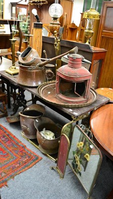 Lot 1153 - A group of metalwares including copper and brass chargers, copper coal scuttles, brass column table