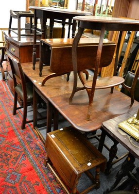 Lot 1154 - Three oak occasional tables, an oak gate leg dining table, a carved oak stool, savonarola style...