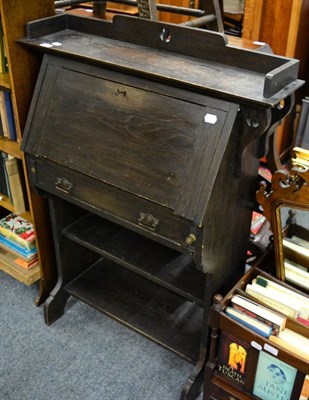 Lot 1157 - An oak drop leaf occasional table, four tier bookcase and Canterbury containing a collection of...