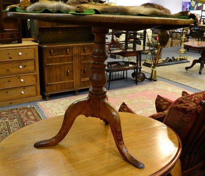 Lot 1180 - A George III oak tilt top tripod table