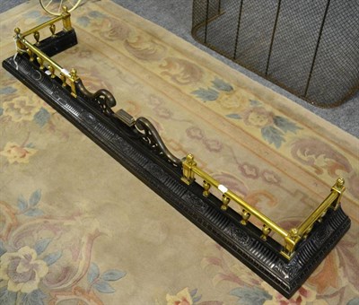 Lot 1203 - A cast iron and brass fender