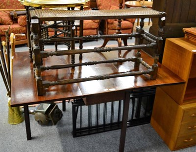 Lot 1215 - A mahogany drop leaf table, tripod table and a cane work stool