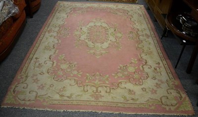 Lot 1217 - Savonnerie design carpet, probably China, the candy pink field centred by a medallion framed by...