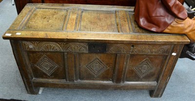 Lot 1341 - An 18th century three panel oak coffer containing a quantity of curtains