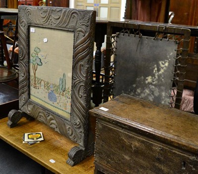 Lot 1351 - Two fire screens, one with a needlework panel, the other tooled leather