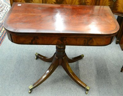 Lot 1365 - A late George III mahogany fold over games table