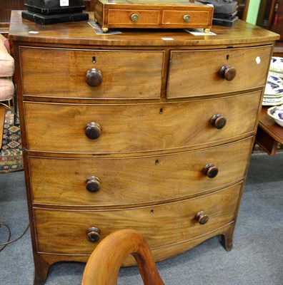 Lot 1377 - A George III mahogany bow fronted four height chest of drawers