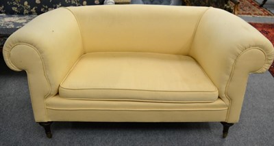 Lot 1392 - A cream upholstered Chesterfield type sofa with mahogany frame