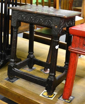 Lot 1425 - A 17th century and later oak joint stool, carved seat