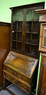 Lot 1453 - An oak bureau bookcase