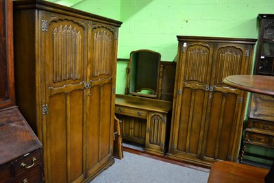 Lot 1454 - A four piece Old Charm linen fold carved oak bedroom suite and two mirrorrs