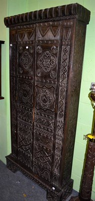 Lot 1461 - An ornately carved Provincial oak two-door cupboard