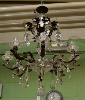 Lot 1471 - A cut glass and gilt metal eight-branch chandelier, of graduated form with faceted drops,...