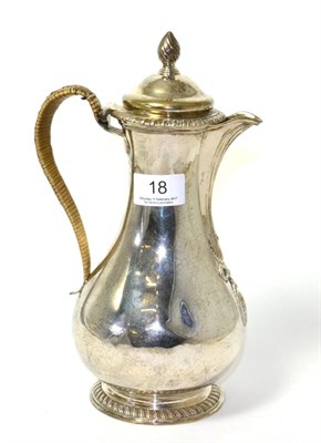 Lot 18 - A George III silver hot water jug and cover, maker's mark a.f., London 1773, of pear shape repousse