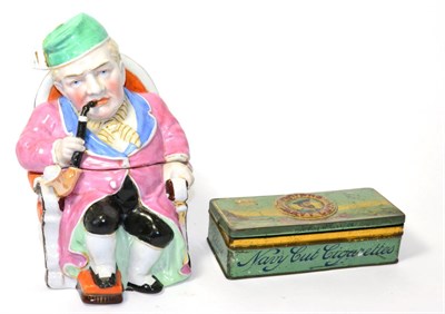 Lot 20 - A German ceramic figural tobacco jar in the form of a seated gentleman smoking a pipe, with a...