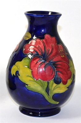 Lot 48 - Walter Moorcroft vase in the Hibiscus pattern with impressed and painted marks, 19cm high