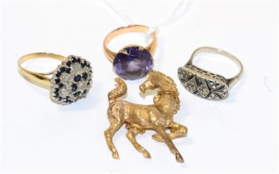 Lot 127 - A synthetic colour change sapphire ring, a sapphire and diamond cluster ring, a horse brooch...