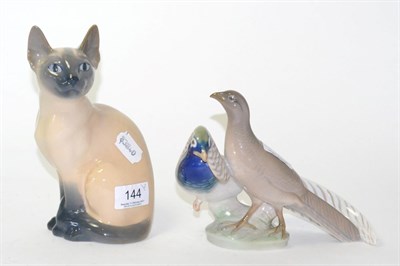 Lot 144 - A Royal Copenhagen porcelain model of a seated Siamese cat, 20cm high; and a similar group of...