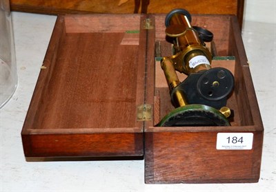 Lot 184 - A cased microscope containing glass slides