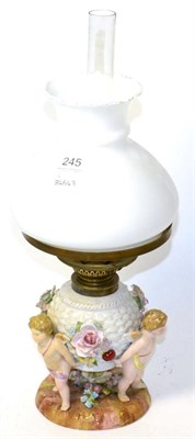 Lot 245 - Continental porcelain figural oil lamp with opaque shade