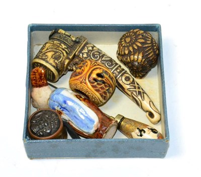 Lot 263 - Six Japanese curiosities comprising pottery netsuke, two ojime, scribe's pen case, satsuma hat...