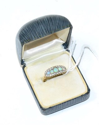 Lot 274 - An opal and diamond ring, five graduated round cabochon opals within a border of eight-cut diamonds