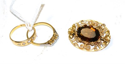 Lot 284 - A citrine brooch, a five stone diamond ring and a three stone diamond ring