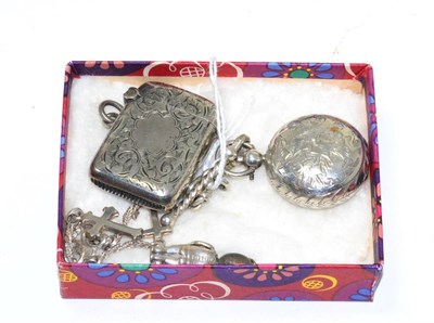 Lot 310 - A silver sovereign case, Chester hallmark, a silver vesta case and two silver charms (4)