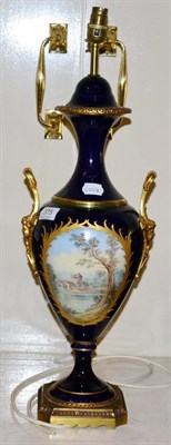 Lot 375 - A modern Sevres style table lamp in cobalt blue with gilt highlights, depicting an amorous...