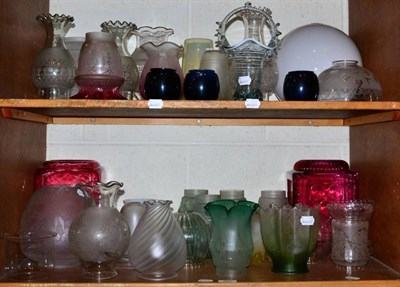 Lot 380 - Two shelves of various 19th century light shades including etched, vaseline, cranberry, opaque etc.