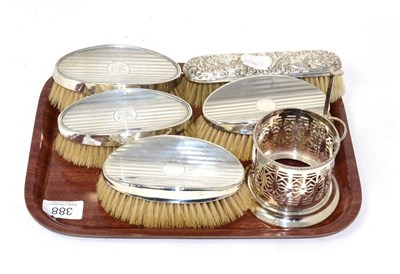 Lot 388 - Five dressing table silver mounted brushes and a silver bottle holder