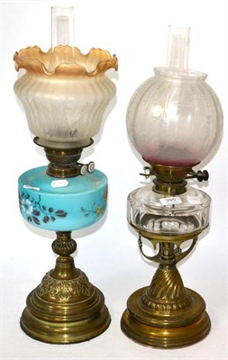 Lot 395 - Two Victorian oil lamps one with a clear glass reservoir, the other with a turquoise and floral...