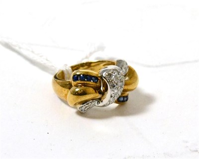 Lot 480 - A sapphire and diamond bow ring, pavé set with round brilliant cut diamonds and channel set with